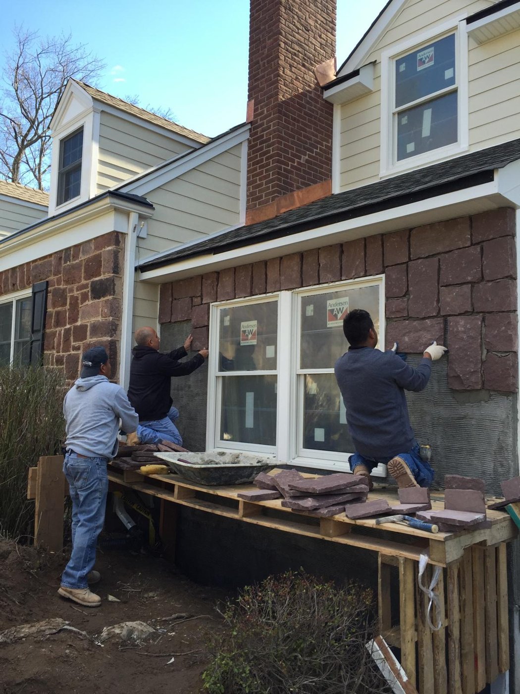 Masons hand setting stone to match facade Bergen County NJ Bergen Remodeling